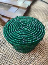 Load image into Gallery viewer, Coiled green basket on a woven surface