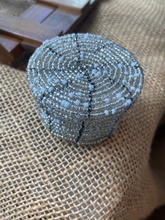 Load image into Gallery viewer, Silver glittery beaded basket on a textured surface