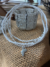 Load image into Gallery viewer, Beaded bracelet with a small container on a textured surface